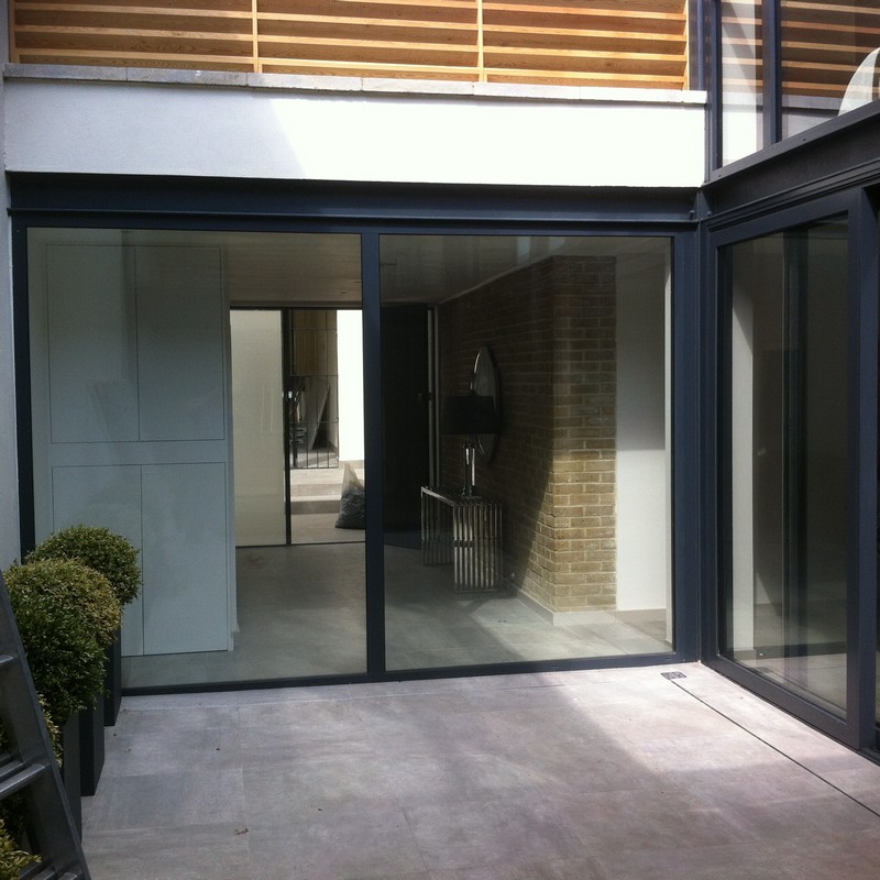 Floor-to-ceiling sliding doors opening to courtyard in Holloway