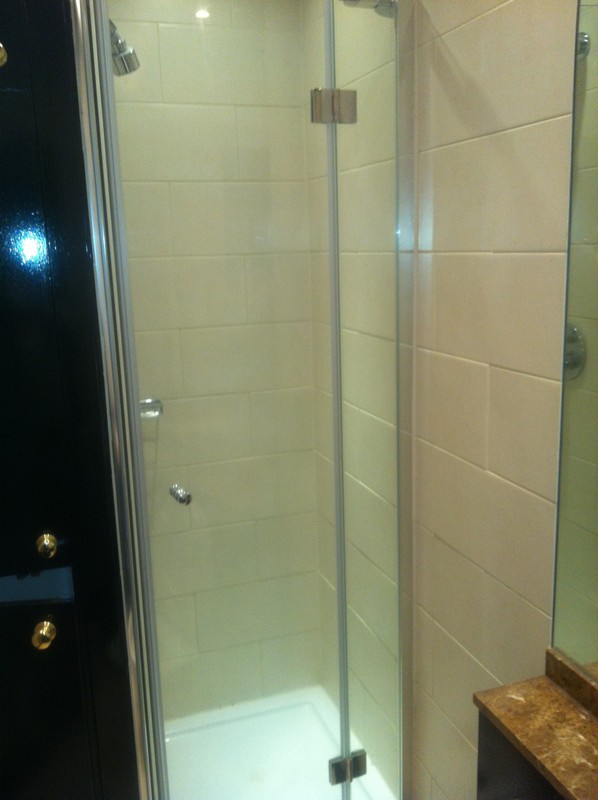 Frameless glass shower enclosure with chrome fittings in Holloway